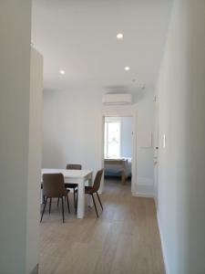 a white dining room with a table and chairs at Brezza Marina in Massa Lubrense +75 photos