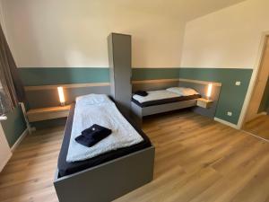 a room with two beds and a mirror at A2rooms in Lehnin