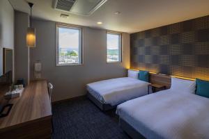Voodi või voodid majutusasutuse Kiryu Grand Hotel toas