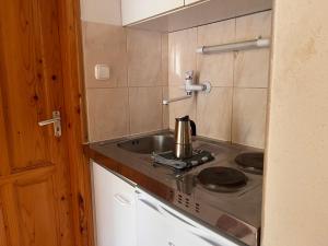 a kitchen with a tea kettle on a stove at Klassz Apartmanház in Balatonfüred