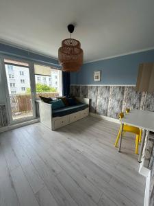 a living room with a couch and a table at Apartament Heljan, 150 m od plaży in Gdańsk