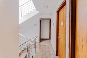 an empty hallway with stairs and a door at Hotel O South Plaza in New Delhi