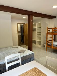 a room with two beds and two chairs and a closet at Motorest SKI Čertovica in Liptovská Sielnica