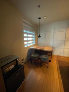 a room with a table and a table and a window at Makati City The Serenity Tower 2512A in Manila