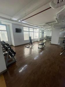 an empty room with a gym with chairs and weights at Makati City The Serenity Tower 2512A in Manila