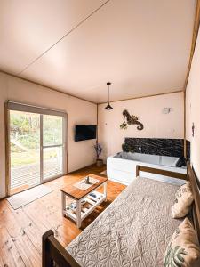 a bedroom with a bed and a table in a room at Brisa del Sur Lofts in La Paloma