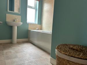 a bathroom with a sink and a tub and a toilet at Grand View in Scarborough