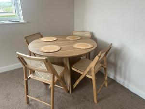 a wooden table with two chairs and a wooden table and chairsktop at Grand View in Scarborough +14 photos