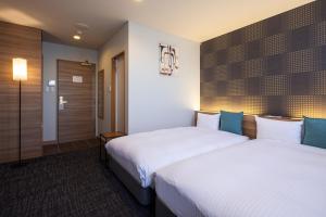 Voodi või voodid majutusasutuse Kiryu Grand Hotel toas
