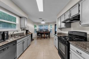 a kitchen with stainless steel appliances and a dining table at Prime Round Rock, TX Getaway home in Round Rock