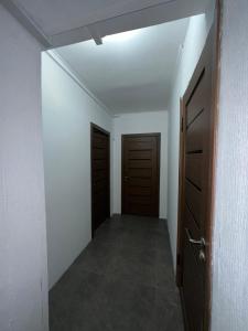 an empty room with two doors and a hallway at Room Hostel Tolebi in Almaty +45 photos