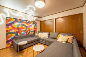 a living room with a couch and a painting at Third Place Nagano in Matsumoto +43 photos