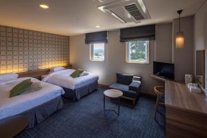 Voodi või voodid majutusasutuse Kiryu Grand Hotel toas