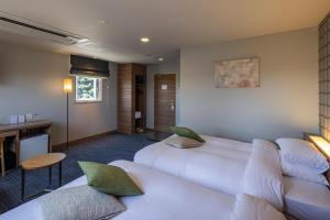 Voodi või voodid majutusasutuse Kiryu Grand Hotel toas