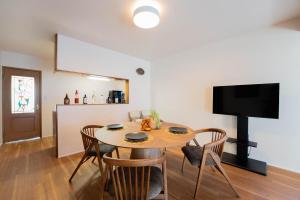 a kitchen and dining room with a table and chairs at Third Place Nagano in Matsumoto