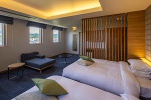 Voodi või voodid majutusasutuse Kiryu Grand Hotel toas