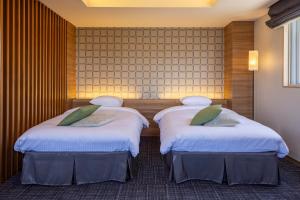Voodi või voodid majutusasutuse Kiryu Grand Hotel toas