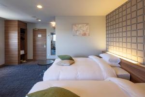 Voodi või voodid majutusasutuse Kiryu Grand Hotel toas