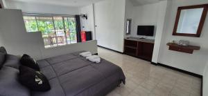 a bedroom with a bed with a stuffed animal on it at Palmgarden Resort Samui - only Adult - neu Saniert in Ban Tai