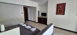 a living room with a couch and a television at Palmgarden Resort Samui - only Adult - neu Saniert in Ban Tai