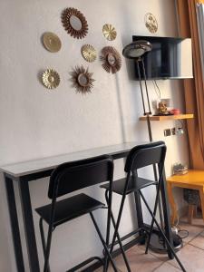 a table with two chairs and some mirrors on the wall at Magnifique studio centre-ville in Nice