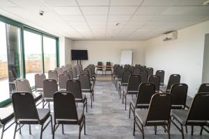 an empty room with chairs and a screen in it at Skanzen Hotel in Szentendre