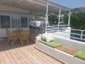 a patio with a table and chairs on a balcony at Kavala Hotel Bodrum in Bodrum City