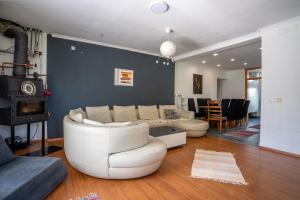 a living room with a white couch and a fireplace at Capital Stay in Sarajevo