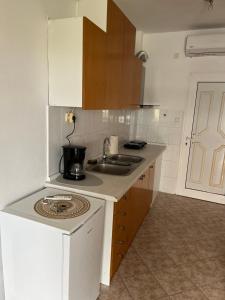 a small kitchen with a sink and a stove at Kallithea Sunlight in Kallithea Halkidikis +3 photos