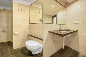 a bathroom with a toilet and a sink at Townhouse Oak City Center Mysore Palace in Mysore