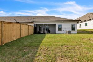 a house with a fence in front of a yard at Modern Nest - Huntsville Hideaway home in Huntsville