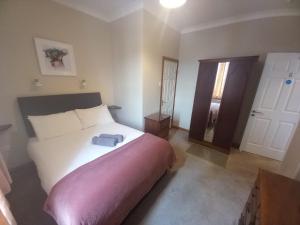 a bedroom with a bed with a blue towel on it at Bay View Guesthouse in Galway