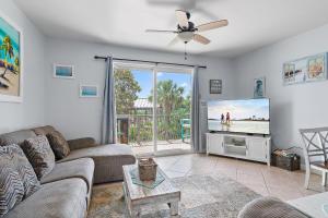a living room with a couch and a flat screen tv at Beach Resort 214 in Destin