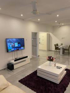 a living room with a flat screen tv on the wall at Premium Apartments in Santeo