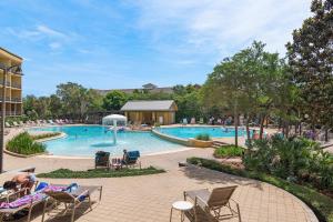 a pool at a resort with people sitting in chairs at Beach Resort 214 in Destin