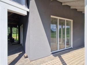 a side of a house with a door and windows at Taadi studio apartment in Loosu