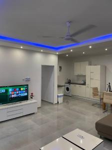 a large living room with a blue led ceiling at Premium Apartments in Santeo