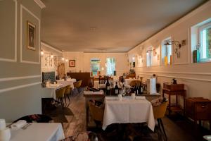 a dining room with tables and chairs and a restaurant at Locanda Gaudemus Boutique Hotel in Sistiana