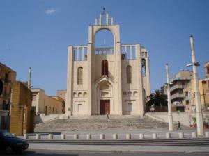 a white church with a large tower in a city at Vecchia Sicilia in Gela +12 photos