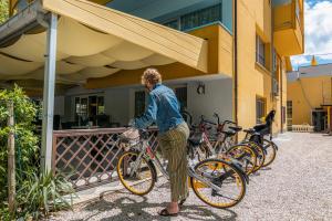 a man standing next to a row of bikes at Hotel & Residence Parador in Cesenatico