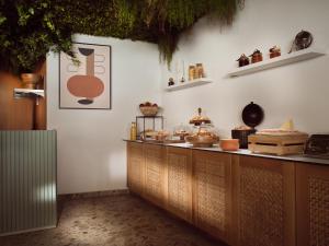 a kitchen with a counter with food on it at Ammonites Beachfront Rooms & Suites in Laganas