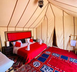 a bedroom with two beds in a tent at Outdoor luxury camp in Merzouga +45 photos