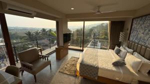 a bedroom with a bed and a large window at Titanic Boutique Hotel in Baga