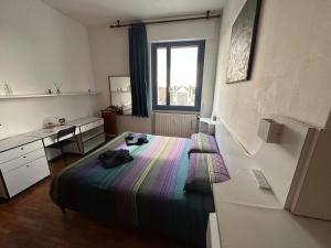 a bedroom with a bed and a desk and a window at CASABELLA in Monza +48 photos