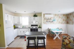 a kitchen with white cabinets and a table at The John Randall House in Provincetown