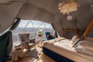 a bedroom with a bed in a tent at Tatra Glamp Bukowina Tatrzańska - Sieć noclegowa Tatra Glamp in Bukowina Tatrzańska
