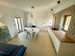 a kitchen with a table and a dining room at Studio Vila Olga in Dutovlje