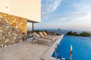 a patio with chairs and a swimming pool at Villa Mare in Petrovac na Moru