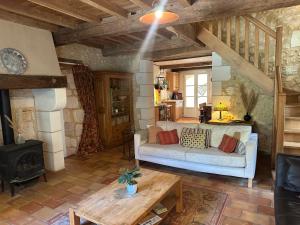 a living room with a couch and a stove at Gites Boutique in Villamblard