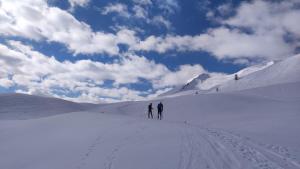 two people are skiing on a snow covered slope at Mizoun Paola Via Roma 9 in Aisone +7 photos